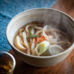 a bowl of soup with noodles and vegetables