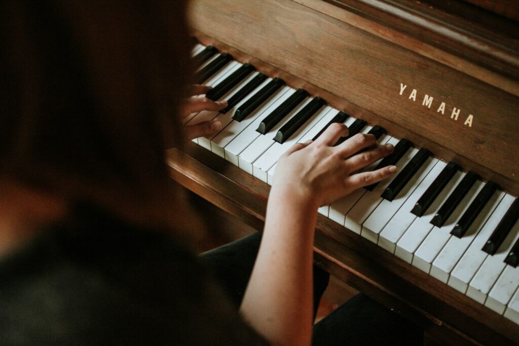 woman playing Yamaha piano